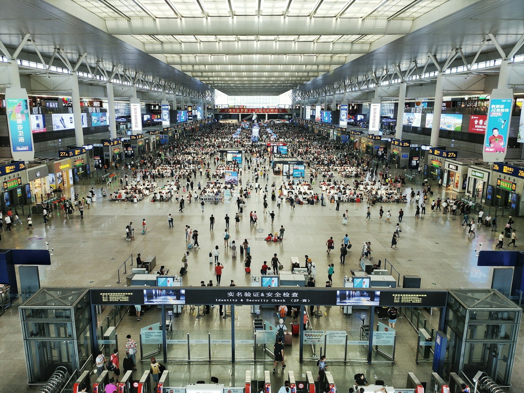 A busy railway station hall in Shanghai, seen from above